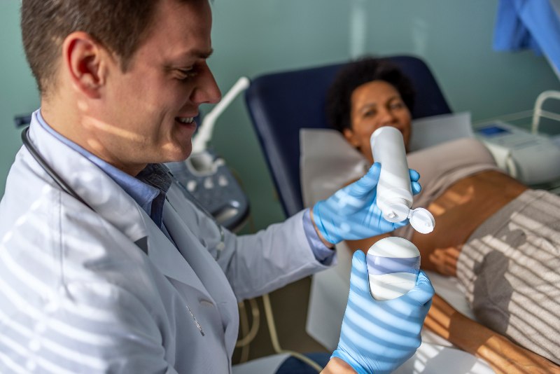 Woman waiting to get a doppler ultrasound from a doctor by Arizona Vein & Laser Institute